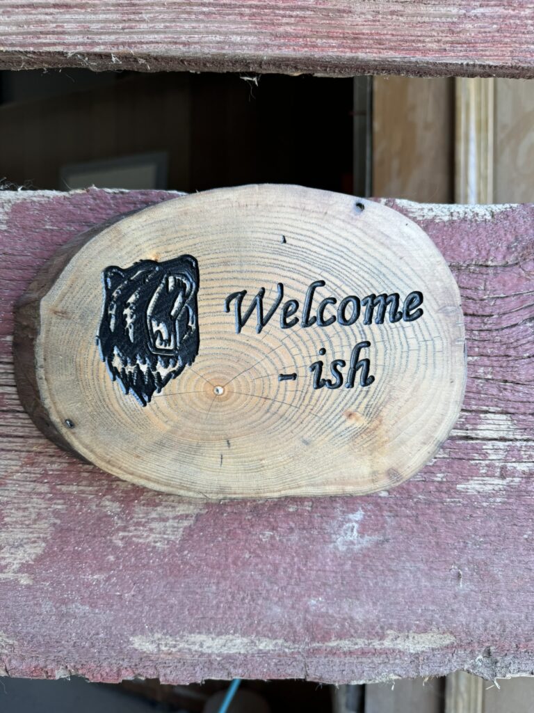 Log End Oval Welcome ish Bear